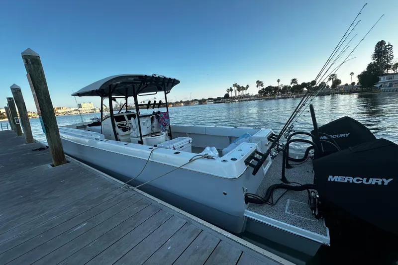  Yacht Photos Pics 2022 Eastward 30 boat docked, equipped with Mercury engines, fishing rods visible.