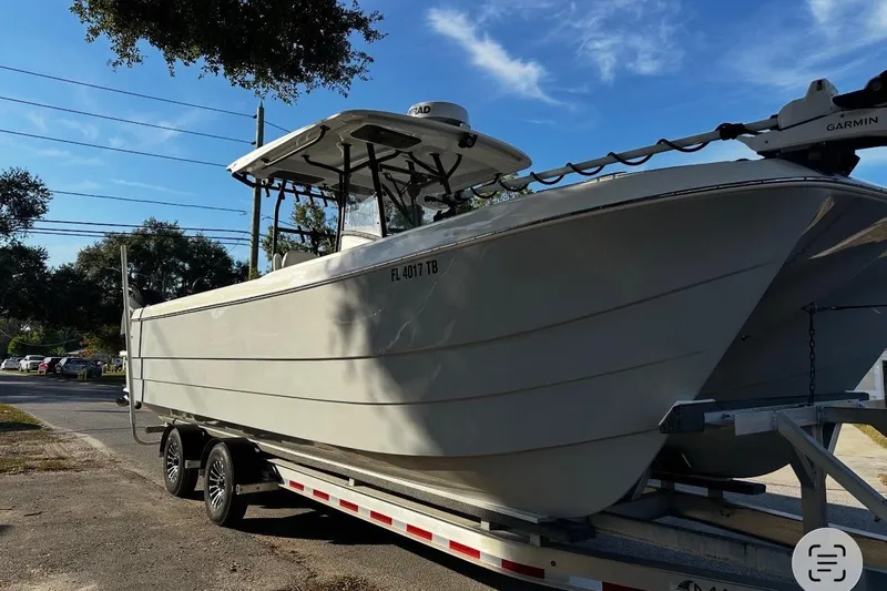  Yacht Photos Pics 2022 Eastward 30 boat on trailer, parked outdoors under a clear blue sky.
