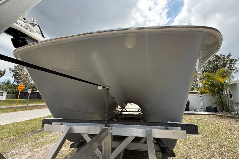  Yacht Photos Pics 2022 Eastward 30 boat on trailer, viewed from the front under a cloudy sky.