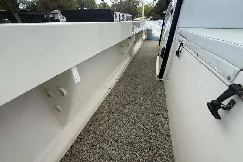  Yacht Photos Pics Side view of 2022 Eastward 30 boat with white railing and textured flooring.