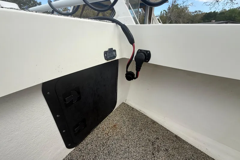  Yacht Photos Pics Interior view of a 2022 Eastward 30 boat showing wiring and storage compartment.