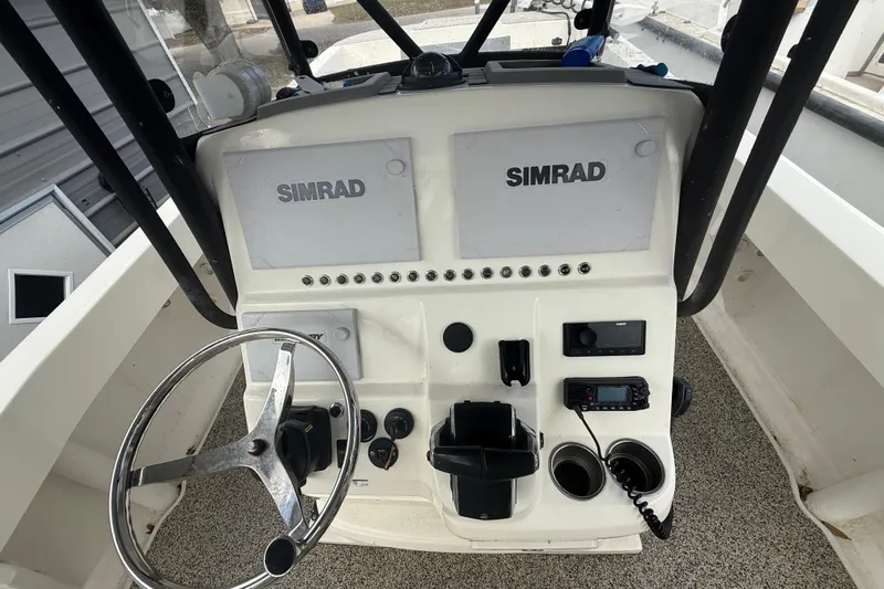  Yacht Photos Pics Control panel of a 2022 Eastward 30 boat with Simrad displays and steering wheel.