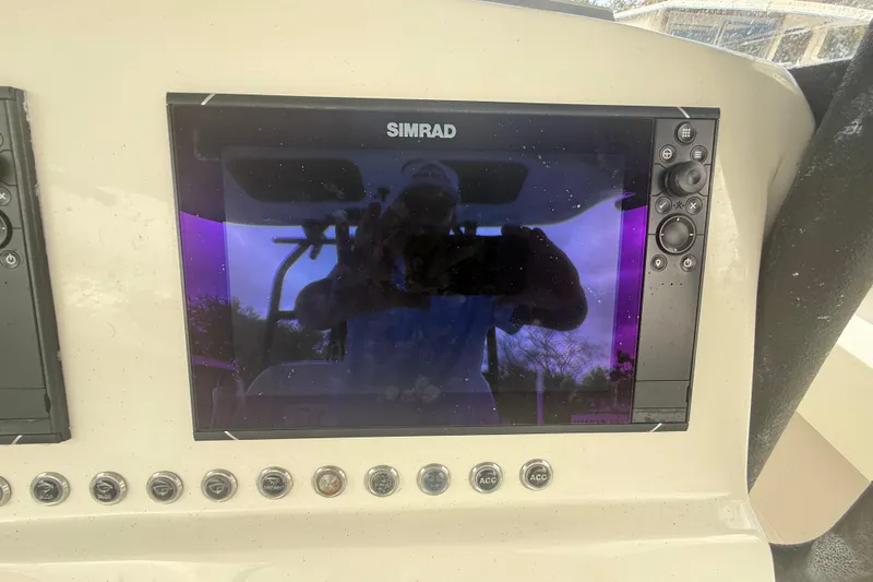  Yacht Photos Pics Simrad display on 2022 Eastward 30 boat dashboard with control buttons.