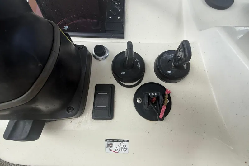  Yacht Photos Pics Control panel of a 2022 Eastward 30 boat with ignition switches and safety lanyard.