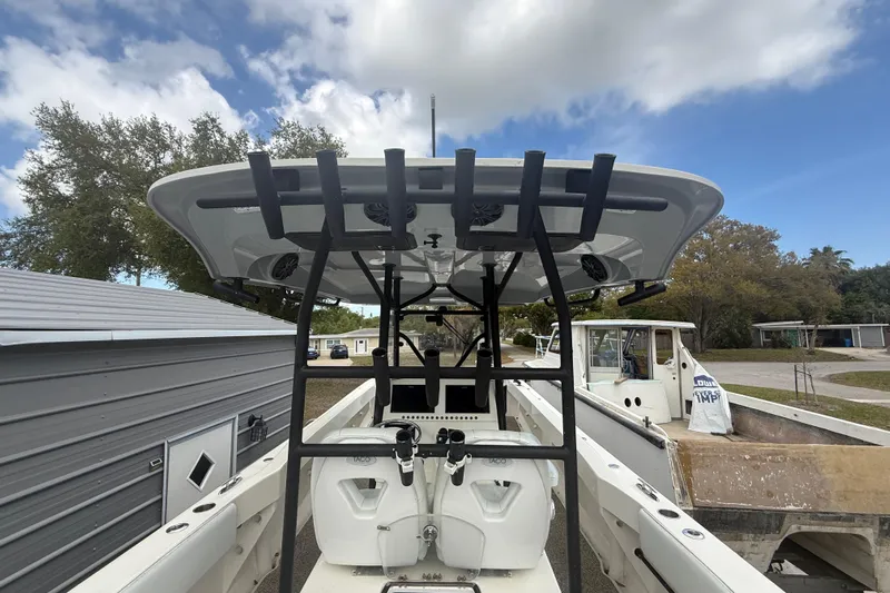  Yacht Photos Pics 2022 Eastward 30 boat with T-top, docked outdoors under a cloudy sky.