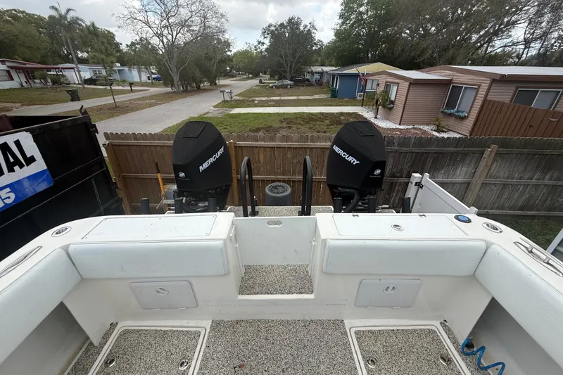  Yacht Photos Pics Eastward 30 boat with dual Mercury engines, parked in a residential area, 2022 model.