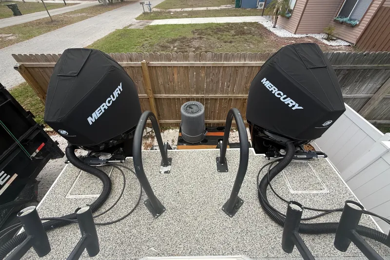  Yacht Photos Pics Twin Mercury outboard motors on a 2022 Eastward 30 boat, parked in a residential area.