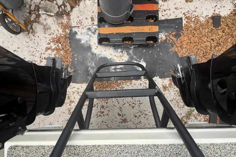  Yacht Photos Pics Top view of Eastward 30 boat ladder and engines, surrounded by leaves and sand.
