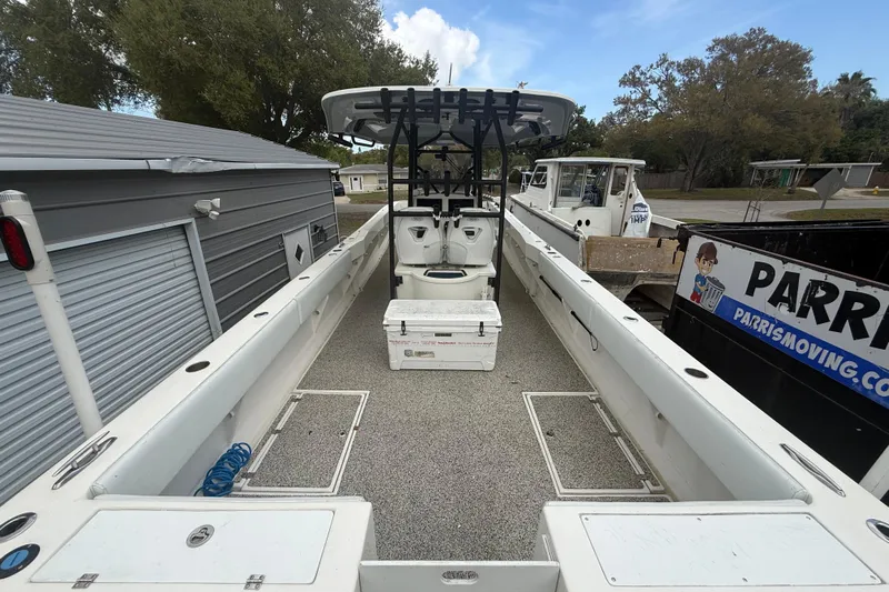  Yacht Photos Pics 2022 Eastward 30 boat interior with seating and storage, docked near a storage facility.