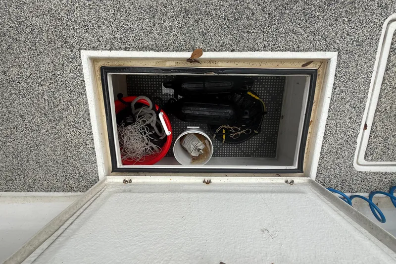  Yacht Photos Pics Open storage compartment on 2022 Eastward 30 boat with fishing gear and equipment.