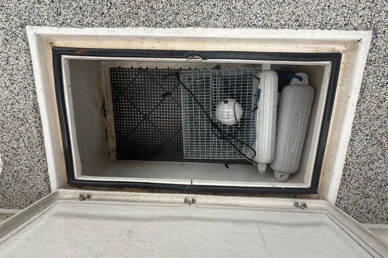  Yacht Photos Pics Storage compartment on Eastward 30 boat, containing fenders and a ball, 2022 model.