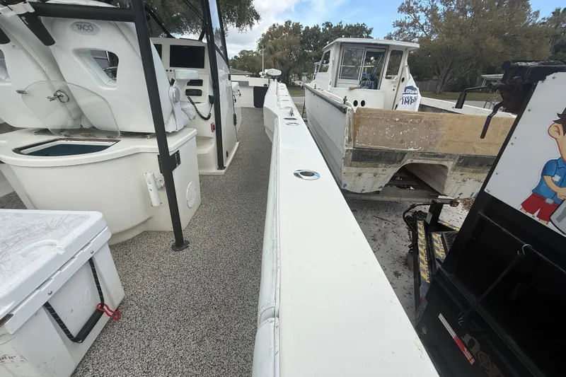  Yacht Photos Pics Interior view of a 2022 Eastward 30 boat, featuring seating and control panel.