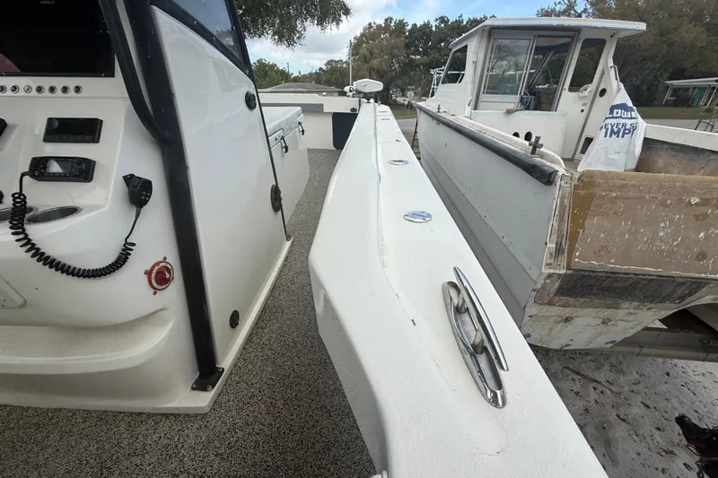 Yacht Photos Pics Interior view of a 2022 Eastward 30 boat, showcasing control panel and deck details.