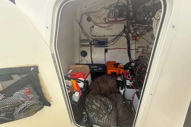  Yacht Photos Pics Interior of 2022 Eastward 30 boat showing storage and electrical components.