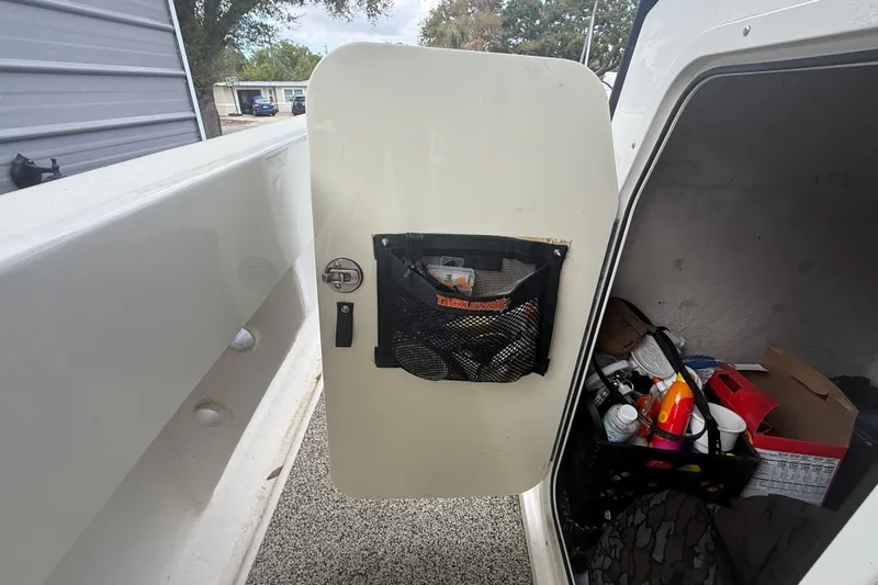  Yacht Photos Pics Open storage compartment on a 2022 Eastward 30 boat, showing organized supplies.