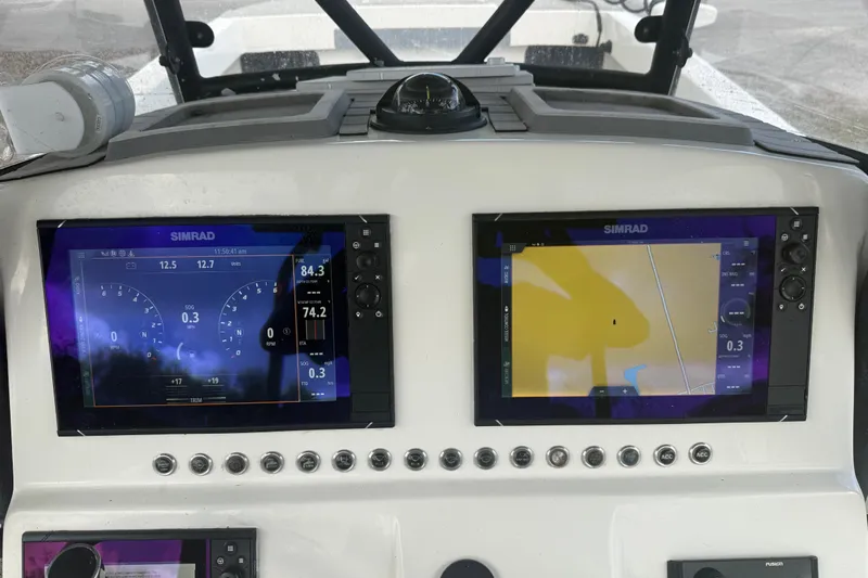  Yacht Photos Pics Simrad navigation displays on 2022 Eastward 30 boat dashboard, showing speed and map data.