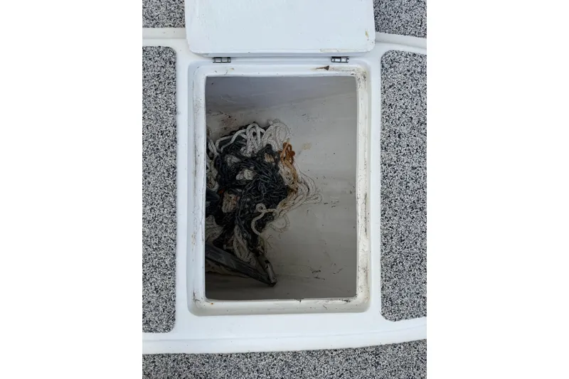  Yacht Photos Pics Open storage compartment on Eastward 30 boat, containing tangled ropes, 2022 model.