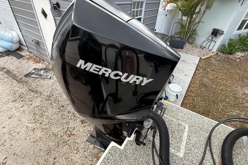  Yacht Photos Pics Mercury outboard motor on 2022 Eastward 30 boat, parked near a house.
