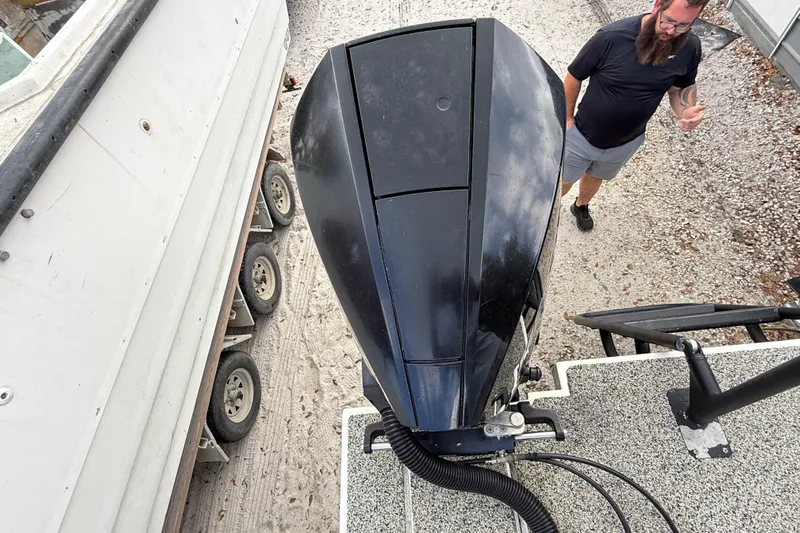  Yacht Photos Pics Overhead view of Eastward 30 boat engine, 2022 model, with a person nearby.