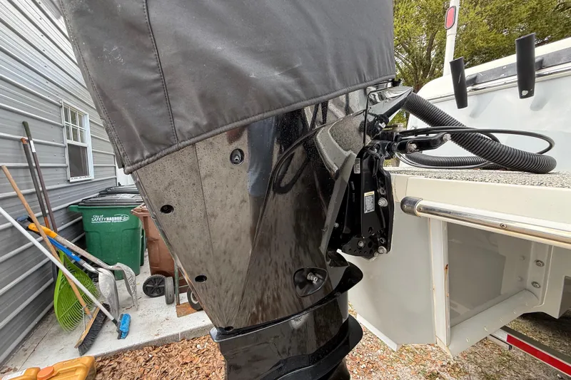  Yacht Photos Pics Outdoor view of a 2022 Eastward 30 boat motor, partially covered, near a garage.