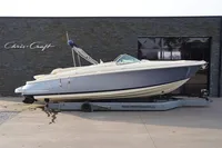 2024 Chris-Craft Launch 28 GT boat on trailer, parked outside showroom.