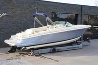 2024 Chris-Craft Launch 28 GT boat on trailer, sleek design, parked outdoors.