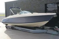 2024 Chris-Craft Launch 28 GT boat on trailer, parked outdoors.