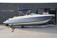 2024 Chris-Craft Launch 28 GT boat with blue hull and canopy on display.
