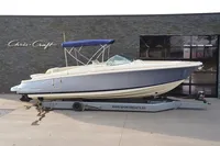 2024 Chris-Craft Launch 28 GT boat on trailer, side view, blue and white design.