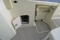 2024 Chris-Craft Launch 28 GT interior, featuring a control panel and carpeted flooring.