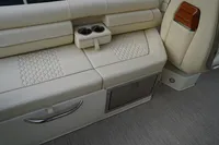 2024 Chris-Craft Launch 28 GT interior seating with cup holders and storage compartment.