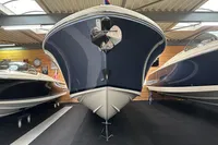 2024 Chris-Craft Launch 28 GT boat in showroom, front view, sleek design.