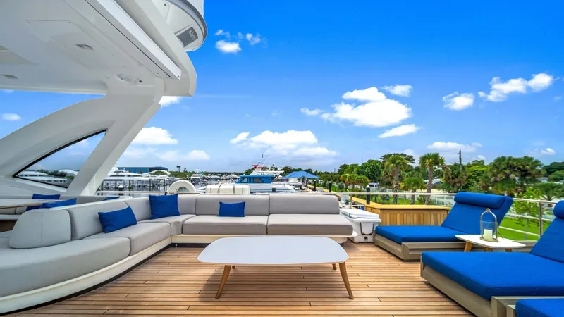 One & Only Yacht Photos Pics Luxurious deck of 2020 Azimut Grande 32 Metri yacht with elegant seating and scenic view.