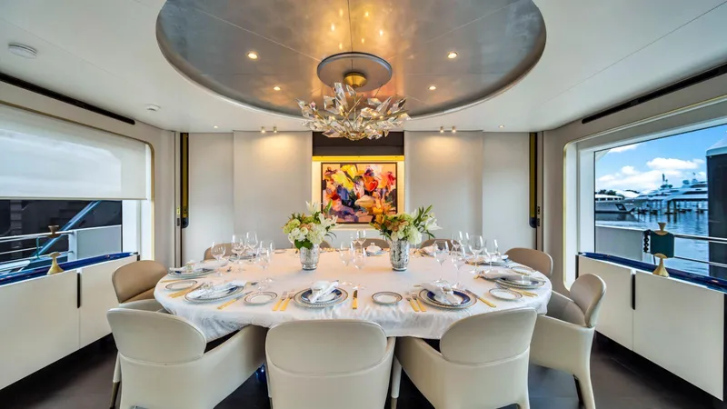 One & Only Yacht Photos Pics Luxurious dining area on 2020 Azimut Grande 32 Metri yacht, elegantly set table, modern decor.