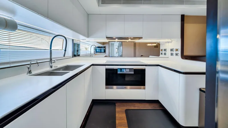 One & Only Yacht Photos Pics Modern kitchen interior on 2020 Azimut Grande 32 Metri yacht, featuring sleek white cabinetry.