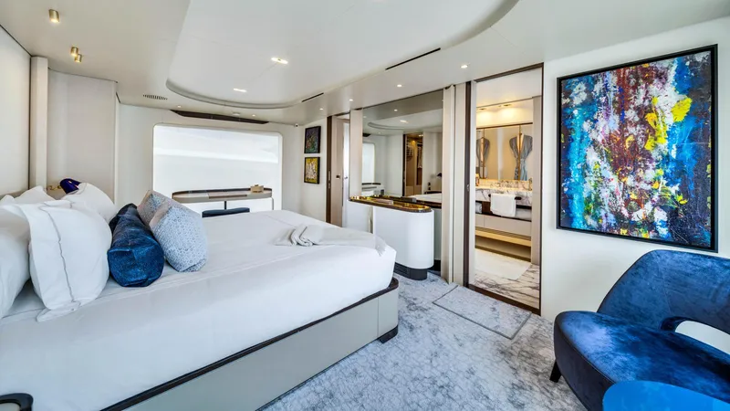 One & Only Yacht Photos Pics Luxurious bedroom interior of 2020 Azimut Grande 32 Metri yacht with modern decor and artwork.