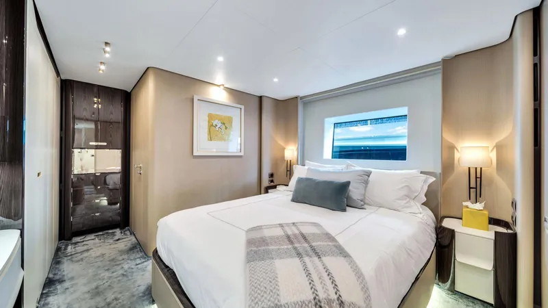 One & Only Yacht Photos Pics Luxurious bedroom interior of 2020 Azimut Grande 32 Metri yacht, featuring elegant decor and modern amenities.