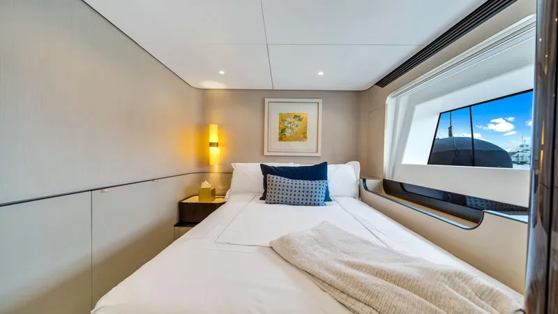 One & Only Yacht Photos Pics Luxurious bedroom interior on 2020 Azimut Grande 32 Metri yacht with modern decor and large window.