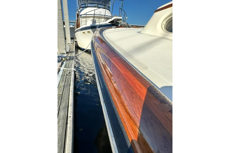 Lida Yacht Photos Pics Hinckley Picnic Boat 36, 2000 model, docked with polished wood detailing and sleek design.