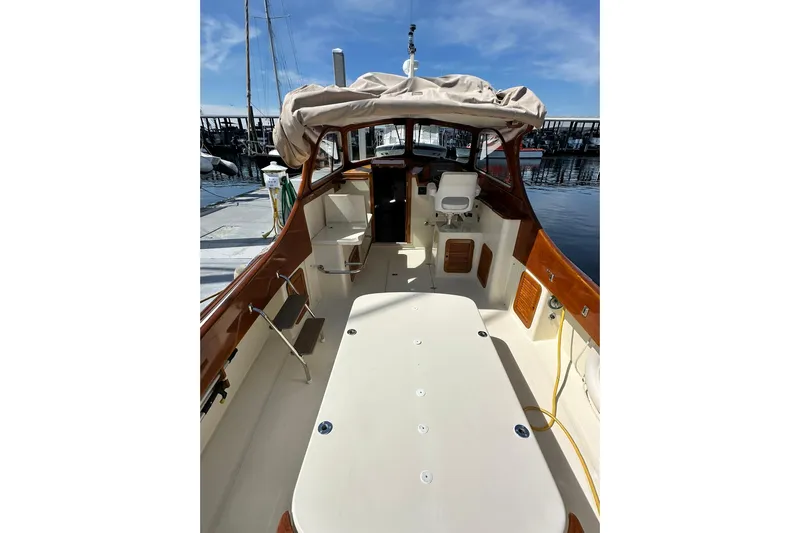 Lida Yacht Photos Pics 2000 Hinckley Picnic Boat 36 interior view at marina, showcasing seating and helm.
