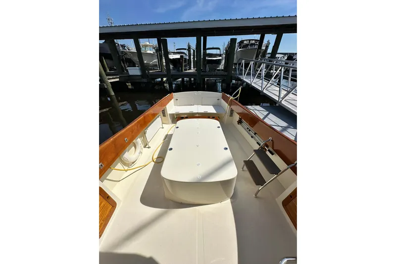 Lida Yacht Photos Pics 2000 Hinckley Picnic Boat 36 docked, showcasing spacious deck and elegant wood finishes.