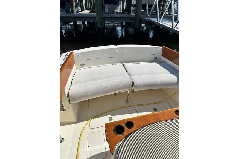 Lida Yacht Photos Pics Hinckley Picnic Boat 36 (2000) with cushioned seating and wooden accents in a marina setting.