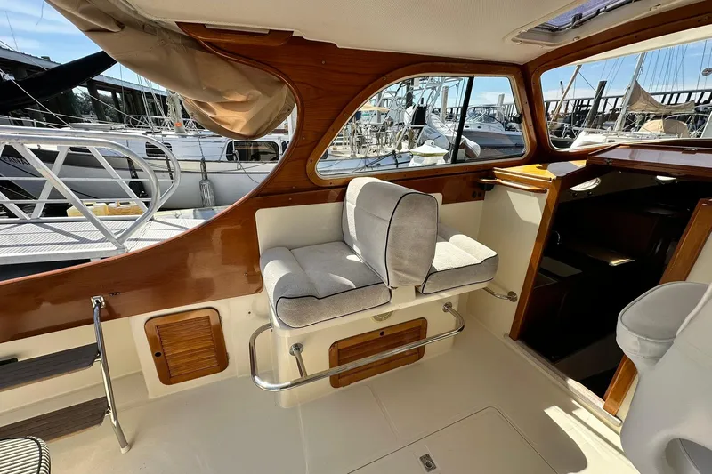 Lida Yacht Photos Pics Interior of 2000 Hinckley Picnic Boat 36 with cushioned seating and wooden accents.