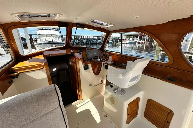 Lida Yacht Photos Pics Interior of 2000 Hinckley Picnic Boat 36 with helm and marina view.