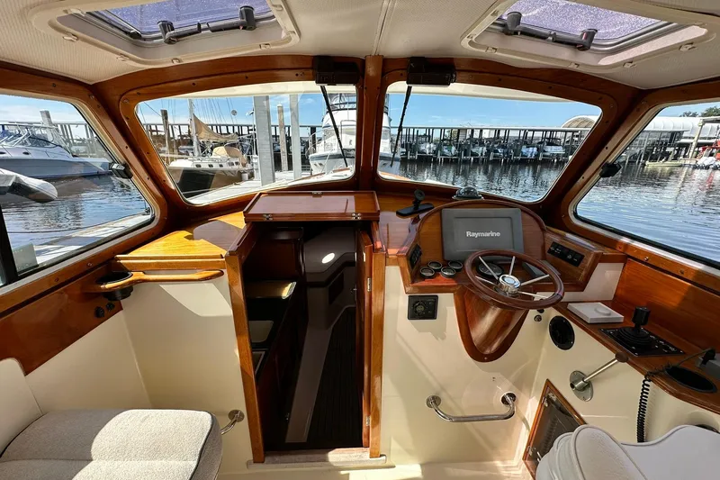 Lida Yacht Photos Pics Interior of 2000 Hinckley Picnic Boat 36 with wooden dashboard and marina view.