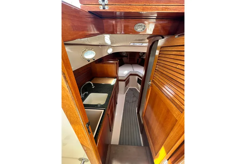 Lida Yacht Photos Pics Interior of 2000 Hinckley Picnic Boat 36 with wood finish and compact kitchen.