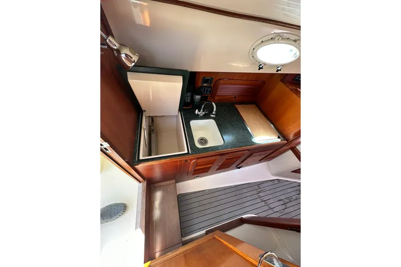 Lida Yacht Photos Pics Hinckley Picnic Boat 36 (2000) interior galley with sink, countertop, and wooden cabinetry.