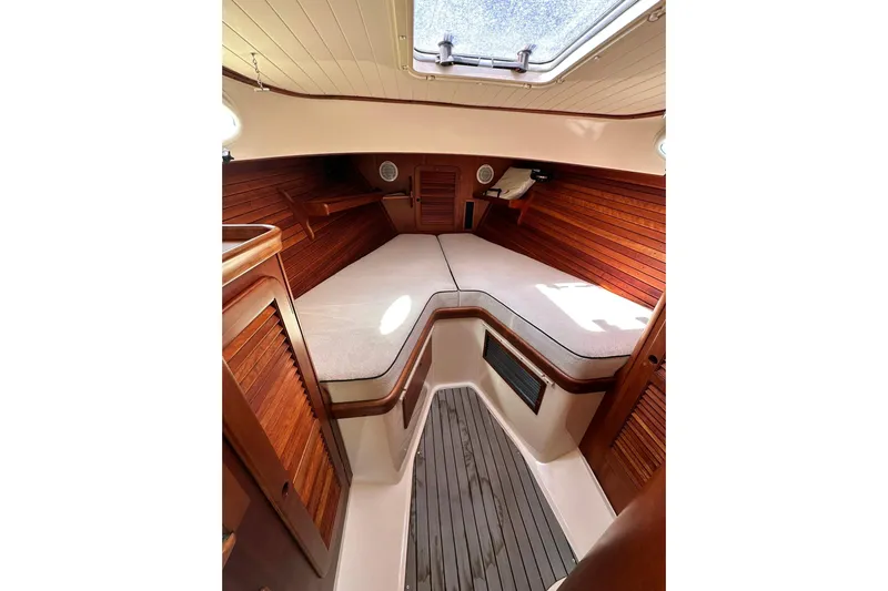Lida Yacht Photos Pics Interior of 2000 Hinckley Picnic Boat 36, featuring cozy wooden cabin and cushioned seating.