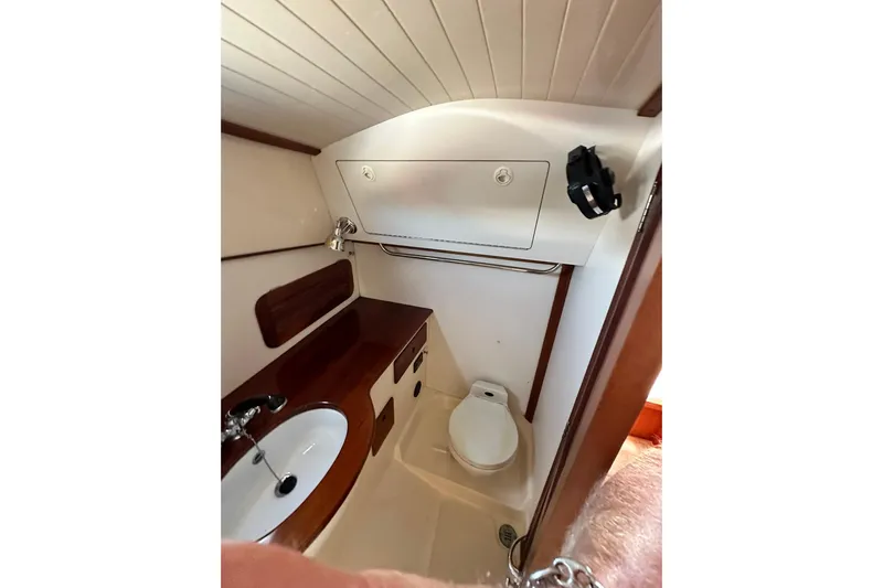 Lida Yacht Photos Pics Hinckley Picnic Boat 36 (2000) bathroom with sink, toilet, and wooden cabinetry.