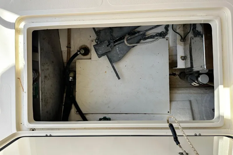 Lida Yacht Photos Pics Anchor storage compartment of 2000 Hinckley Picnic Boat 36, featuring chains and ropes.